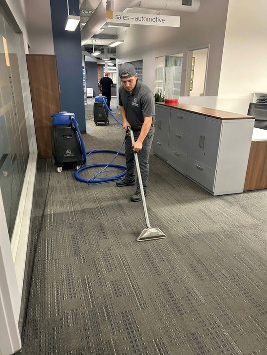 Cleaner deep cleaning an office carpet